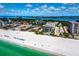 An aerial view shows beachfront condos with white sand, turquoise water, and sunny skies at 845 Benjamin Franklin Dr # 101, Sarasota, FL 34236