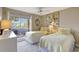 Bedroom with twin beds, a window with outside view, and cozy decor at 845 Benjamin Franklin Dr # 101, Sarasota, FL 34236