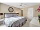 Bedroom with a queen bed, ceiling fan, and access to an adjacent doorway at 845 Benjamin Franklin Dr # 101, Sarasota, FL 34236