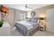 Bright bedroom featuring a queen bed, ceiling fan, and window with outside view at 845 Benjamin Franklin Dr # 101, Sarasota, FL 34236