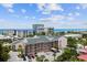 Exterior of tan condominiums with covered carports, palm trees, and tropical landscaping on the coast at 845 Benjamin Franklin Dr # 101, Sarasota, FL 34236