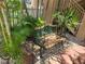 Charming courtyard featuring a decorative bench and lush tropical landscaping at 845 Benjamin Franklin Dr # 101, Sarasota, FL 34236