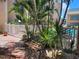 Serene outdoor seating surrounded by tropical plants and view of the community pool at 845 Benjamin Franklin Dr # 101, Sarasota, FL 34236