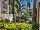Lush courtyard featuring bench seating, vibrant plants and white fence at 845 Benjamin Franklin Dr # 101, Sarasota, FL 34236