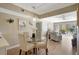 Open-concept dining area with modern light fixture, glass table, and seamless flow to living space at 845 Benjamin Franklin Dr # 101, Sarasota, FL 34236