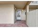 Exterior view of unit entrance with brick pavers, neutral walls, and modern lighting at 845 Benjamin Franklin Dr # 101, Sarasota, FL 34236