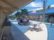 Outdoor seating area with people relaxing, surrounded by palm trees at 845 Benjamin Franklin Dr # 101, Sarasota, FL 34236
