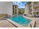 Community pool with clear water, surrounded by lounge chairs and landscaping at 845 Benjamin Franklin Dr # 101, Sarasota, FL 34236