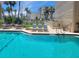 Gorgeous pool with clear water, lounge chairs, and tables for relaxing by the water at 845 Benjamin Franklin Dr # 101, Sarasota, FL 34236