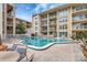 Inviting community pool with lounge chairs and tables, perfect for relaxation and socializing at 845 Benjamin Franklin Dr # 101, Sarasota, FL 34236