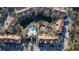 Aerial view of the community features a pool, tennis court, a serene pond, and residential buildings with lush landscaping at 850 S Tamiami Trl # 529, Sarasota, FL 34236
