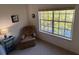 Bedroom corner featuring a chair near a large window with a view of the lush greenery outside at 850 S Tamiami Trl # 529, Sarasota, FL 34236