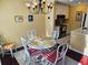 Cozy dining area featuring a stylish chandelier and adjacent kitchen with stainless steel appliances at 850 S Tamiami Trl # 529, Sarasota, FL 34236
