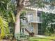 Charming two-story condo with well maintained landscaping, private balconies, and an inviting green bench at 850 S Tamiami Trl # 529, Sarasota, FL 34236