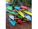 Various kayaks are stored on a wooden rack for residents to access, nestled in a community recreational area at 850 S Tamiami Trl # 529, Sarasota, FL 34236