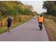 Outdoor path featuring a Personal walking, a bicyclist, and a runner in a serene green setting at 850 S Tamiami Trl # 529, Sarasota, FL 34236