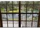 View from the windows looking out on a screened balcony, grassy areas, a pond and a fountain at 850 S Tamiami Trl # 529, Sarasota, FL 34236