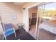 Outdoor balcony showcasing a chair and small table with a partial view of the bright bedroom at 850 S Tamiami Trl # 704, Sarasota, FL 34236