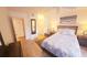 Bright bedroom featuring wood floors, neutral walls, a ceiling fan and a comfortable bed with a decorative comforter at 850 S Tamiami Trl # 704, Sarasota, FL 34236