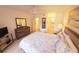 Comfortable bedroom with a large bed, wood floors, neutral walls and a dresser with mirror at 850 S Tamiami Trl # 704, Sarasota, FL 34236