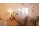 Bright bedroom features a window, ceiling fan, bedside tables, and wood-look flooring at 850 S Tamiami Trl # 704, Sarasota, FL 34236