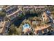 Aerial view highlighting the sparkling pool, community tennis court, and central pond at 850 S Tamiami Trl # 704, Sarasota, FL 34236