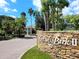 Community sign at entrance amid lush landscaping, welcoming residents and visitors at 850 S Tamiami Trl # 704, Sarasota, FL 34236