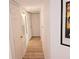 Hallway featuring wood floors, neutral paint, and white doors at 850 S Tamiami Trl # 704, Sarasota, FL 34236