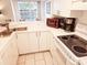 Efficient kitchen with stainless sink, white cabinets, and appliances at 850 S Tamiami Trl # 704, Sarasota, FL 34236