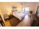 Bright bedroom with balcony access, ceiling fan, and ample closet space at 850 S Tamiami Trl # 704, Sarasota, FL 34236