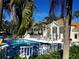 Community pool area surrounded by lounge chairs and mature trees at 850 S Tamiami Trl # 704, Sarasota, FL 34236
