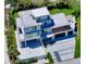 Aerial view of a modern, two-story home featuring balconies, a large in-ground swimming pool, and tropical landscaping at 8800 Midnight Pass Rd, Sarasota, FL 34242