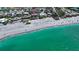 Coastal home with sandy beach and clear turquoise ocean waters at 8800 Midnight Pass Rd, Sarasota, FL 34242