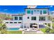 Luxurious backyard featuring a sparkling pool, outdoor kitchen, and stylish patio furniture at 8800 Midnight Pass Rd, Sarasota, FL 34242