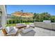 Backyard featuring a patio with a modern fire pit, outdoor kitchen, and comfortable lounge seating at 8800 Midnight Pass Rd, Sarasota, FL 34242