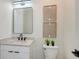Stylish powder room with a sleek mirror, modern lighting, and elegant fixtures for guests at 8800 Midnight Pass Rd, Sarasota, FL 34242
