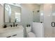 Well-lit bathroom with a vanity, toilet, and a modern glass-enclosed shower with stylish tiling at 8800 Midnight Pass Rd, Sarasota, FL 34242
