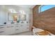 Elegant bathroom with double vanity, soaking tub, wood accent wall, and a glass-enclosed shower at 8800 Midnight Pass Rd, Sarasota, FL 34242