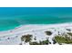 Stunning view of the coastline featuring turquoise waters and a serene sandy beach at 8800 Midnight Pass Rd, Sarasota, FL 34242