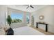 Inviting bedroom with view, light wood floors, and a table with decor at 8800 Midnight Pass Rd, Sarasota, FL 34242