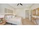 Bedroom featuring a queen bed with light bedding, light hardwood flooring, and decor accents at 8800 Midnight Pass Rd, Sarasota, FL 34242