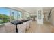 Open-concept dining area with a view of the kitchen, modern design, and natural light at 8800 Midnight Pass Rd, Sarasota, FL 34242