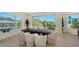Modern dining room with a dark wood table, stylish upholstered chairs, and large windows with a view at 8800 Midnight Pass Rd, Sarasota, FL 34242