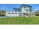 Aerial view of a modern, two-story home featuring an in-ground swimming pool, balconies, and lush landscaping at 8800 Midnight Pass Rd, Sarasota, FL 34242