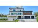Beautiful modern home with a sleek exterior, spacious garage, and minimalist landscaping at 8800 Midnight Pass Rd, Sarasota, FL 34242