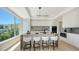 Modern kitchen featuring a central island with bar seating, sleek appliances, and a bright window view at 8800 Midnight Pass Rd, Sarasota, FL 34242