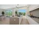 Bright kitchen featuring an island with a sink, stainless steel appliances, and natural light at 8800 Midnight Pass Rd, Sarasota, FL 34242