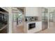 Convenient kitchenette space with a microwave and adjacent staircase at 8800 Midnight Pass Rd, Sarasota, FL 34242
