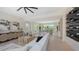 Bright living room with hardwood floors, comfortable white sofa, and a sleek wine rack at 8800 Midnight Pass Rd, Sarasota, FL 34242
