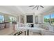 Open-concept living room features modern decor, a comfortable sofa, and easy access to kitchen at 8800 Midnight Pass Rd, Sarasota, FL 34242
